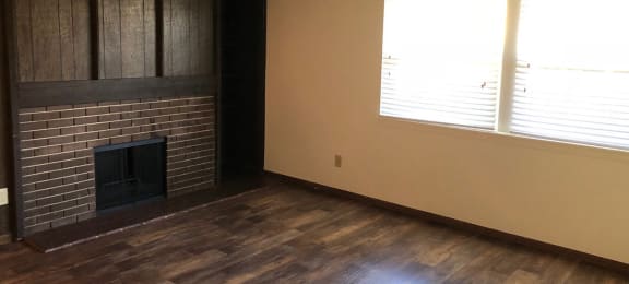 Wood floor living room with fireplace at Raintree Apartments, Topeka, 66614