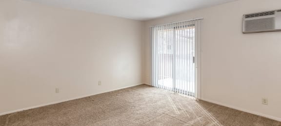 Studio Living Space and Balcony Door at Raintree Apartments, Topeka, KS, 66614