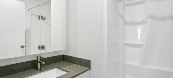 a bathroom with a sink and shower in a 555 waverly unit