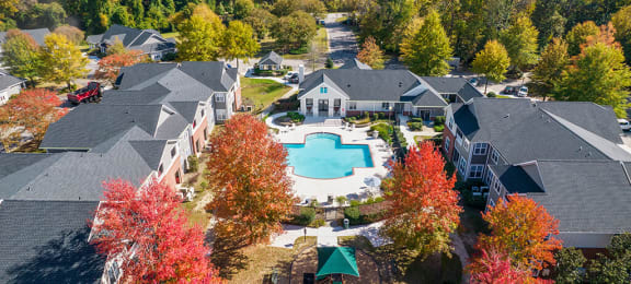 Aerial view of pool with trees surrounding at Grand Oaks in Chester VA