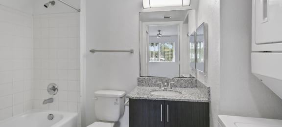 Bathroom with in unit laundry at Brenton at Abbey Park Apartments in West Palm Beach FL