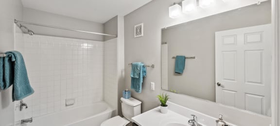 Bathroom with shower and sink at England Run Apartments in Fredericksburg VA