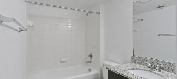 Bathroom with shower tub at Brenton at Abbey Park Apartments in West Palm Beach FL