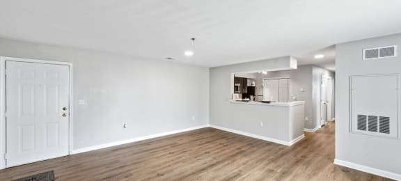 Open concept apartment with hardwood style flooring at England Run Apartments in Fredericksburg VA