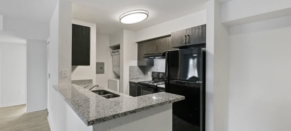Kitchen counter and appliances at Brenton at Abbey Park Apartments in West Palm Beach FL