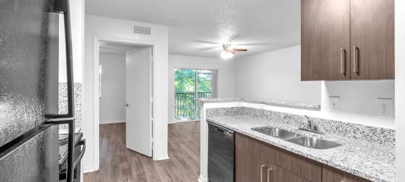Kitchen with cabinets and fridge at Cedar Grove Apartments in Miami Gardens FL