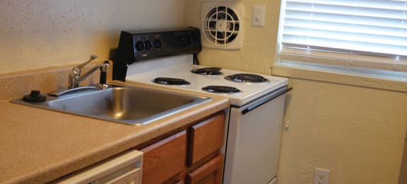 Stove and counter space at Whispering Oaks Apartments in Portsmouth VA