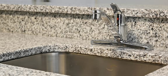 Granite kitchen counter top at Brenton at Abbey Park Apartments in West Palm Beach FL