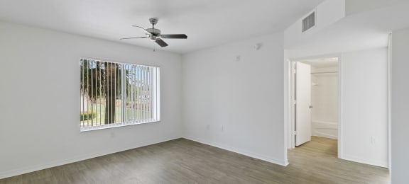 Living room with view of hallway at Brenton at Abbey Park Apartments in West Palm Beach FL