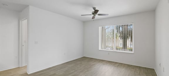 Living room with ceiling fan at Brenton at Abbey Park Apartments in West Palm Beach FL
