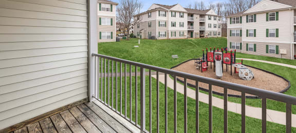 Apartments for Rent in Fredericksburg - England Run North - Playground with Climb Equipment and Slide Surrounded by Grass
