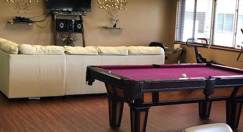 couch, tv, and pool table in community room at Deedco Gardens Senior Apartments