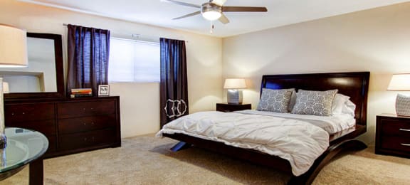 Spacious bedroom with ceiling fan and walk-in closet at Plantation apartments near the Galleria in Houston.