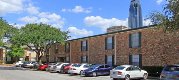 Apartments near the Galleria with brick exteriors, covered parking and courtyard setting at Plantation apartments in Houston.
