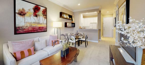 Spacious living room, spacious dining room, kitchen with granite countertops, white cabinets, and breakfast bar at Tuscany Court Apartments in Houston.