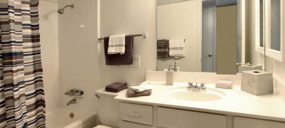 Spacious bright white bathroom at Briarwood Apartments in Houston.