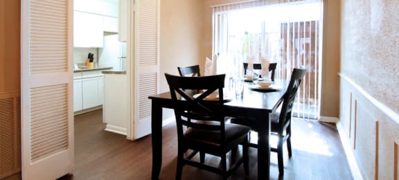 Spacious dining room with hardwood floors at Briarwood apartments in Houston.