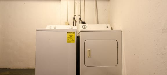 two white washers and dryers in a room