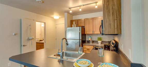 a kitchen with stainless steel appliances and a counter top with plates on it