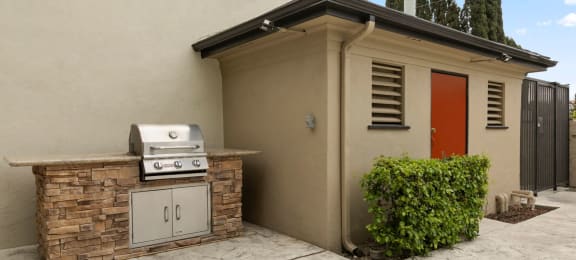 Apartments for Rent in Van Nuys - Colonial Manor - Built-in Barbeque Grill, Small Shrubs, and Outdoor Entrance