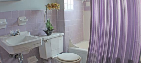a bathroom with a toilet, sink, and bathtub  at Valley York Apartments, Parma Heights, OH, 44130