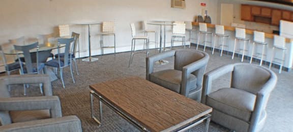 a large community room with tables and chairs  at Valley York Apartments, Parma Heights