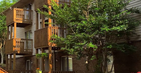 lushly landscaped apartments with flowers and trees around balconies