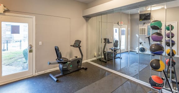 a gym with a glass wall and exercise equipment
