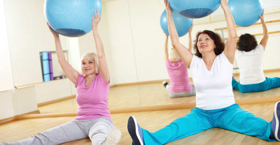 Senior in Fitness Center With Yoga/Stretch Area at 55+ FountainGlen Terra Vista, Rancho Cucamonga