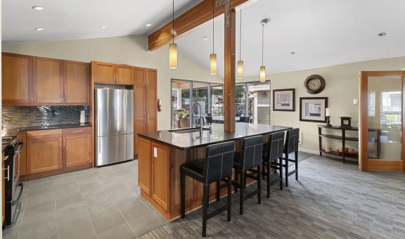 a large kitchen with a large island with chairs