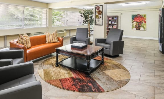 community room with ample seating, large windows, and more at Florida Christian Apartments