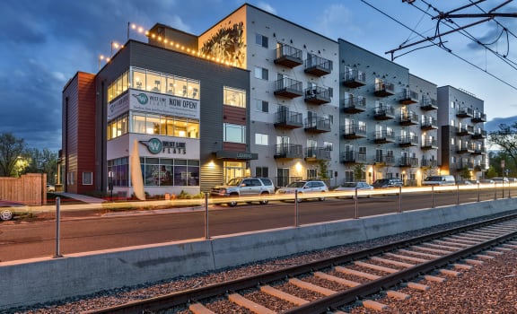 an apartment building with a train track in front of it