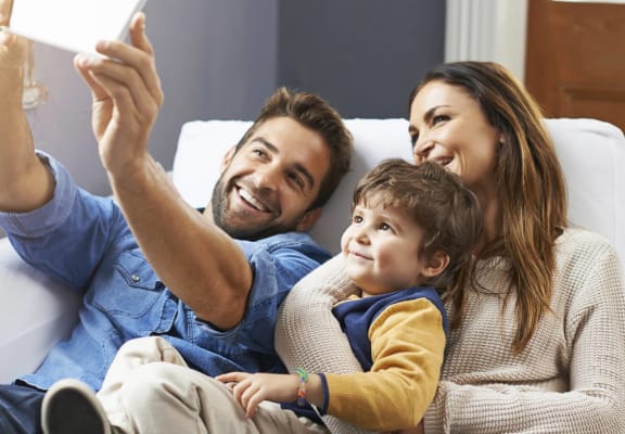 family taking a selfie on a couch