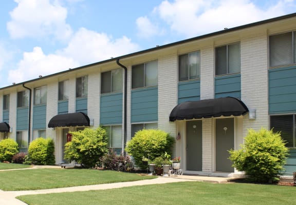 well-kept Sherwood Park Apartment homes exterior with fresh paint, door awnings, and neat landscaping  at Huntsville Landing Apartments, Alabama, 35806
