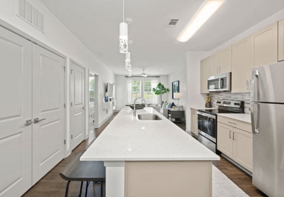 a large white kitchen with a white counter top