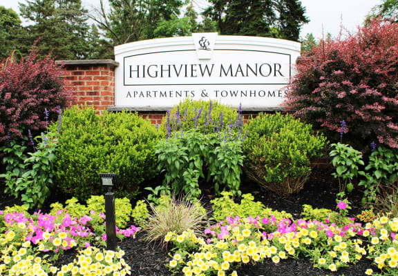 a sign for highview manor apartments and townhomes