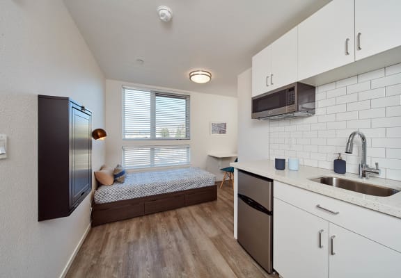 a kitchen and bedroom in a 555 waverly unit