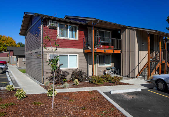an image of an apartment building with a car parked in front of it