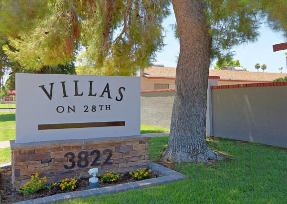 a home with a sign that says villas on 28th