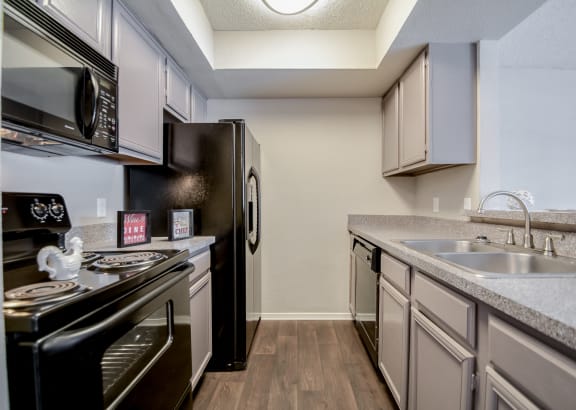 Efficient Appliances In Kitchen at Trinity Village Apartments, Dallas, TX, 75287