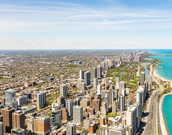 A cityscape with a coastline and a clear sky.