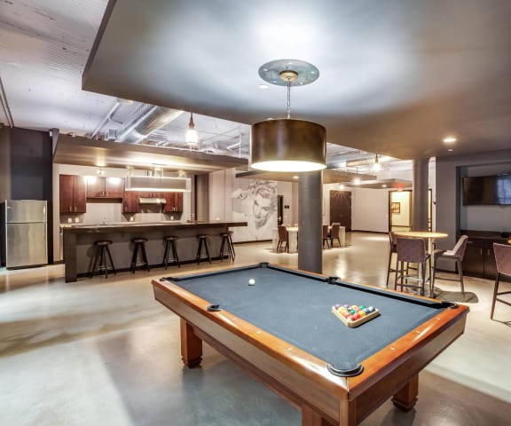 a pool table in the resident lounge at the bradley braddock road station apartments