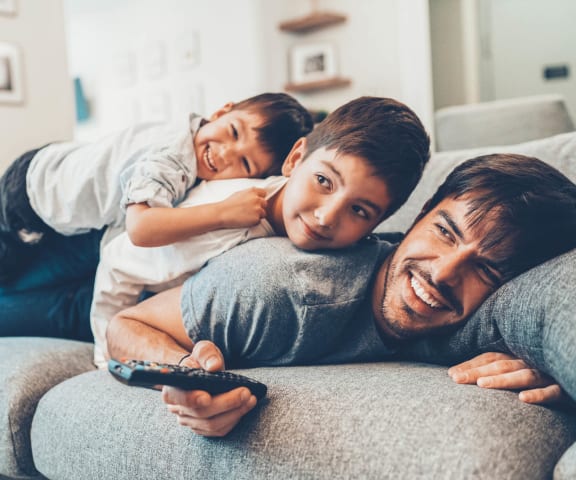 stock image- family on couch watching TV