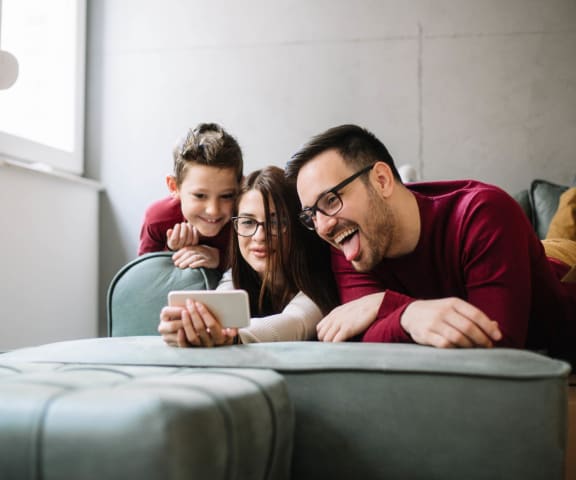 stock image- family on couch with phone
