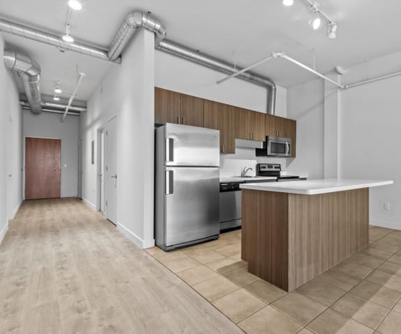 a kitchen with an island and stainless steel appliances
