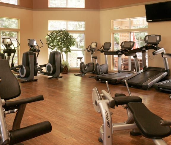 a gym full of exercise equipment in a home gym