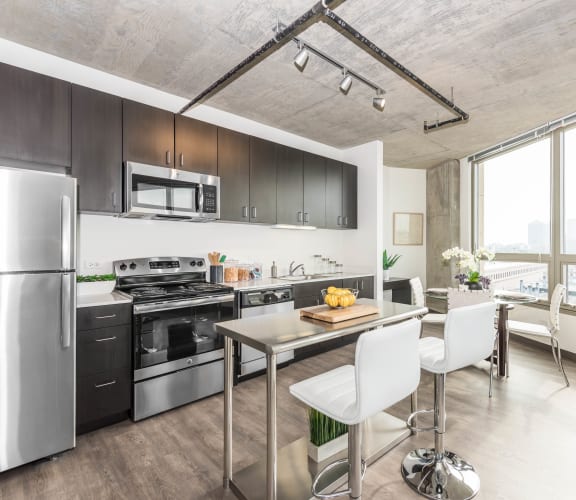 a kitchen and dining area in a 555 waverly unit at Lakeview 3200 Apartments, Chicago, IL, 60657