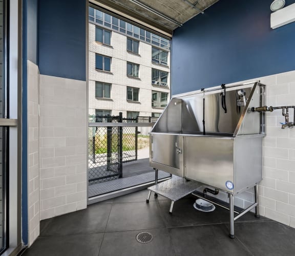 a large stainless steel tub sits in the corner of a room with a balcony in the background at Lakeview 3200 Apartments, Chicago, IL, 60657