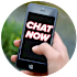 A hand holding a smartphone with the screen displaying "CHAT NOW".