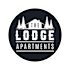 The image is of a logo for "The Lodge Apartments" featuring a black and white design with trees and a house silhouette.